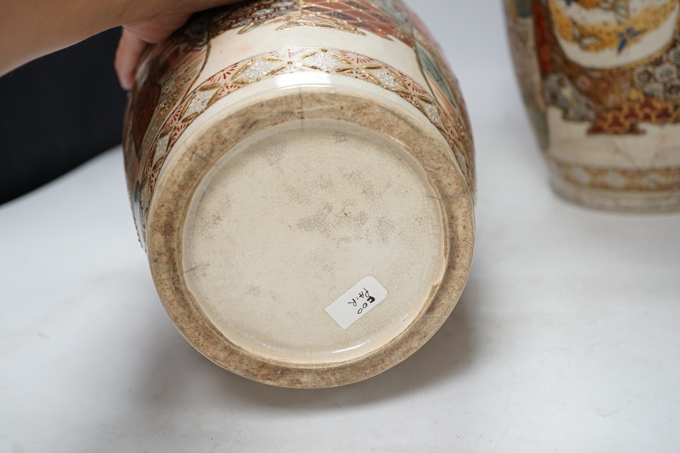 A pair of early 20th century Japanese Satsuma vases, 31cm high. Condition - poor, one repaired